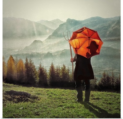 Farmer with an orange umbrella overlooking the Swiss landscape