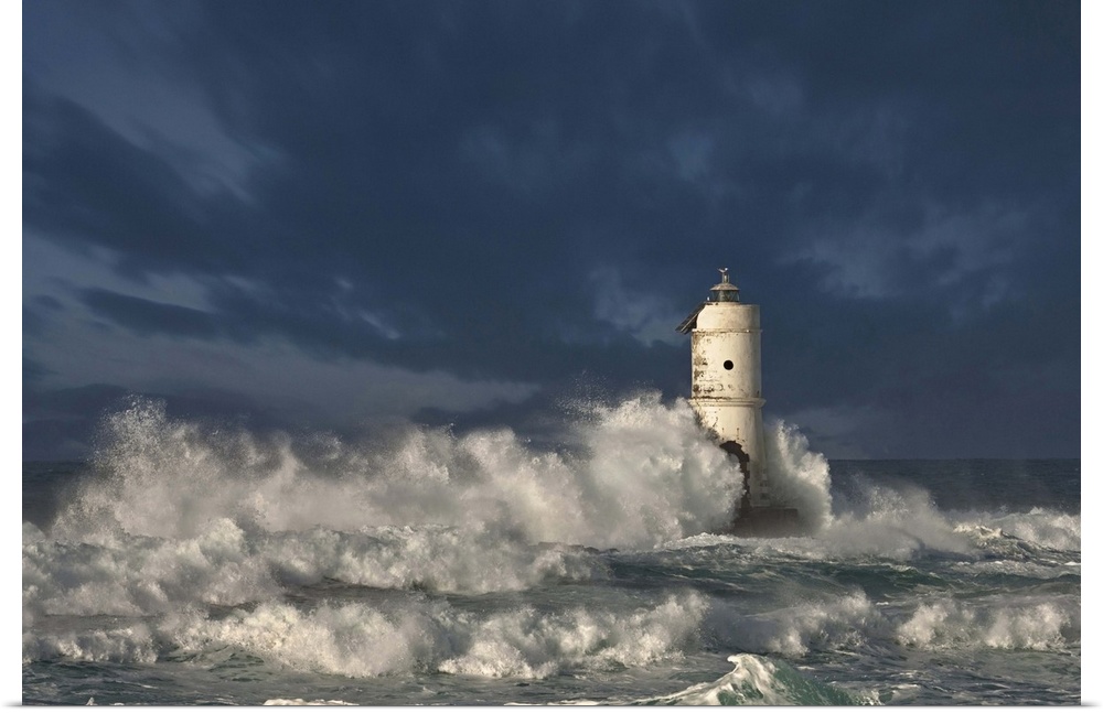 Ocean waves crashing on a lighthouse in Calasetta, Province of Carbonia-Iglesias, Italy.