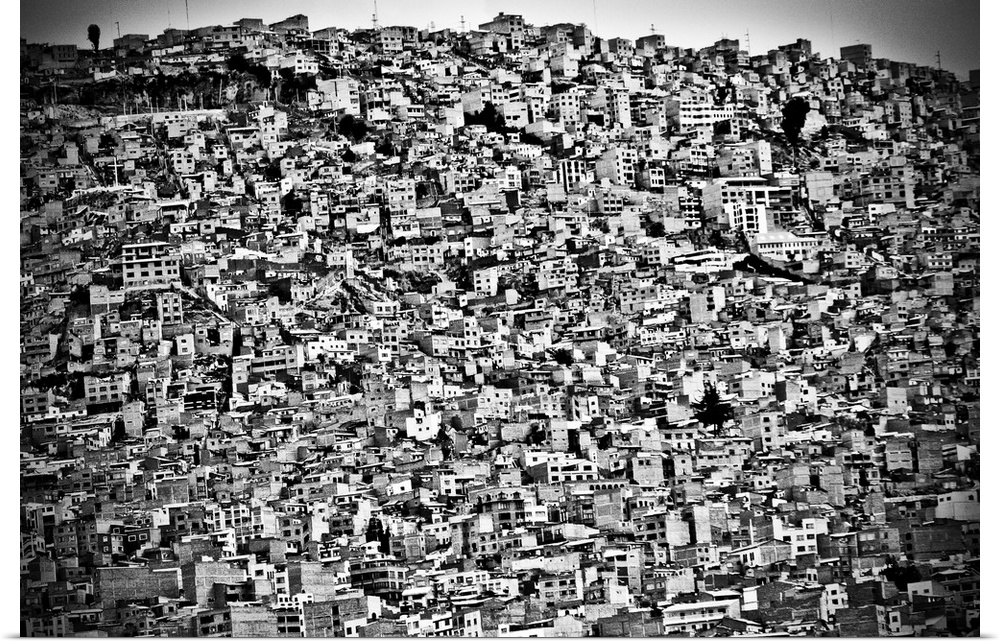 A black and white photograph of the cluttered mass of houses stacked on top of one another in Bolivia.