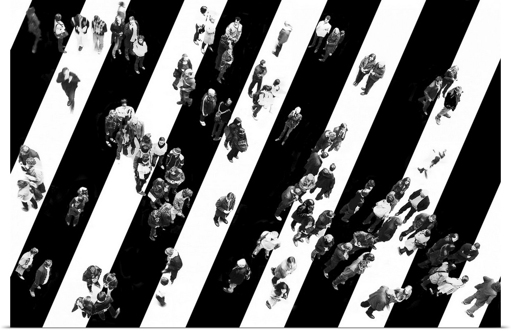 Black and white aerial image of a group of people standing in a striped road.