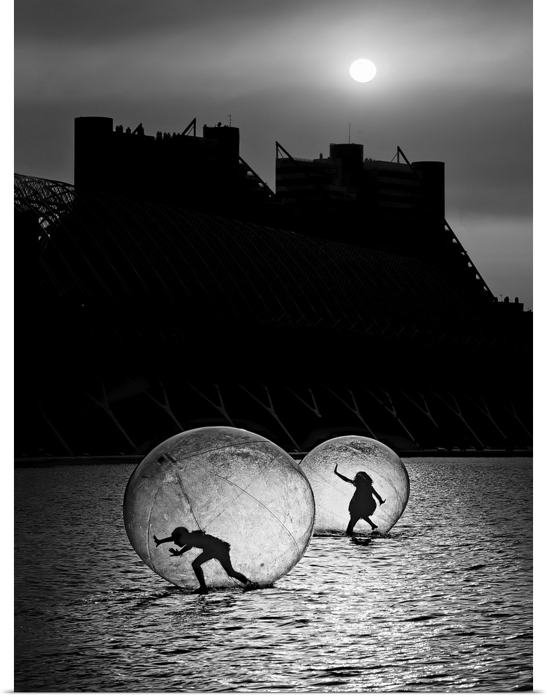 Two human bubbles housing silhouetted figures treading along a watery surface under moonlight.