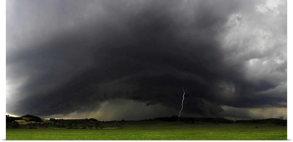 "Rolling Thunderstorms," a bolt of lightning strikes the ground from dark stormclouds over a green field.