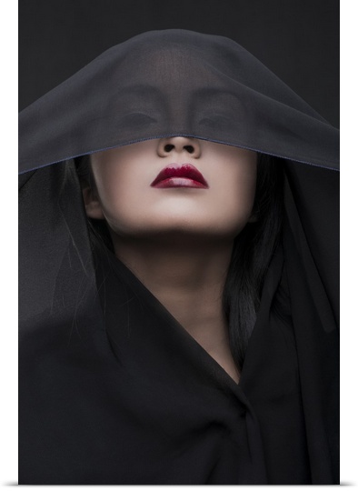 Portrait of a woman with red lipstick and a black veil over her eyes.