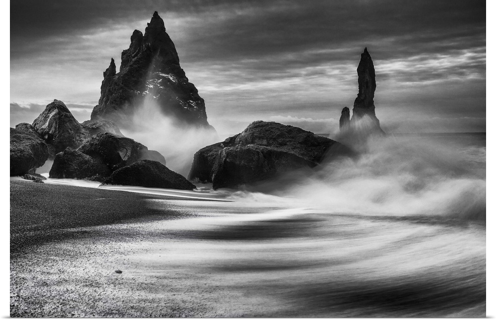 Waves crashing on tall rock spires in Iceland.