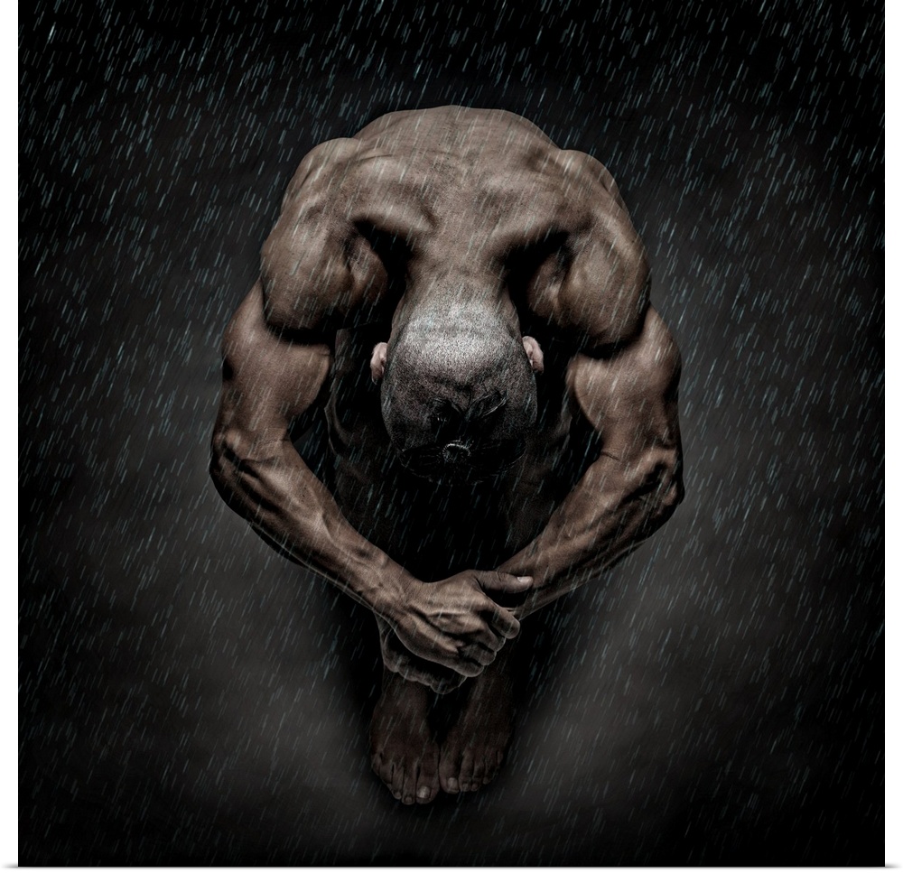 Nude fine art photograph of a muscular man sitting in a ball while it rains.