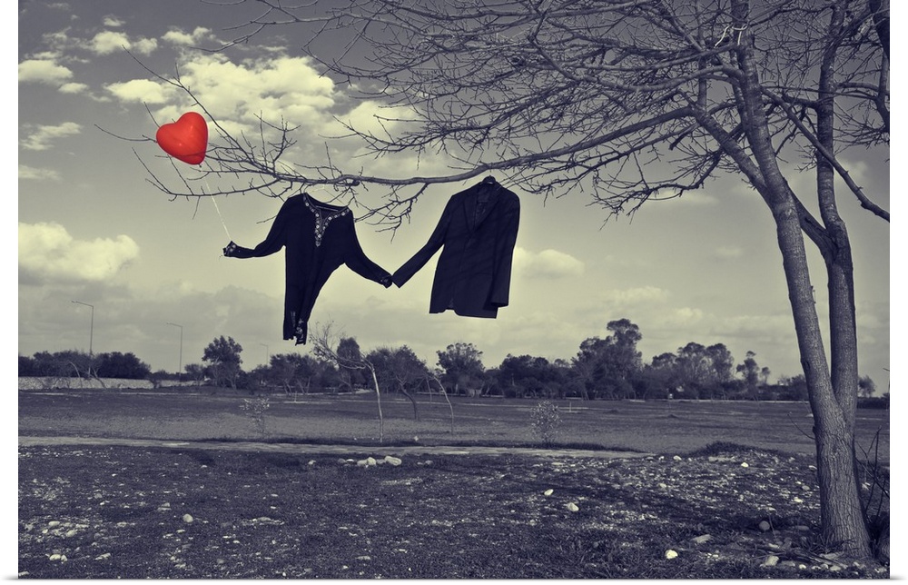 Antique style photograph with a woman's shirt and a man's jacket hanging on a tree holding hands, with a heart shaped red ...