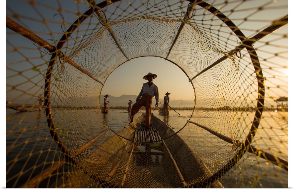 Looking down the conical shaped net laying on a fisherman's boat in the early morning light.