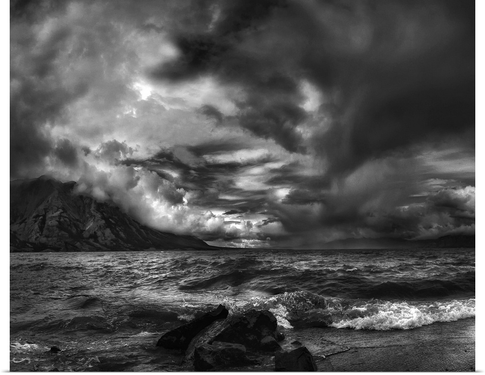 A seascape under a blanket of aggressive looking clouds.
