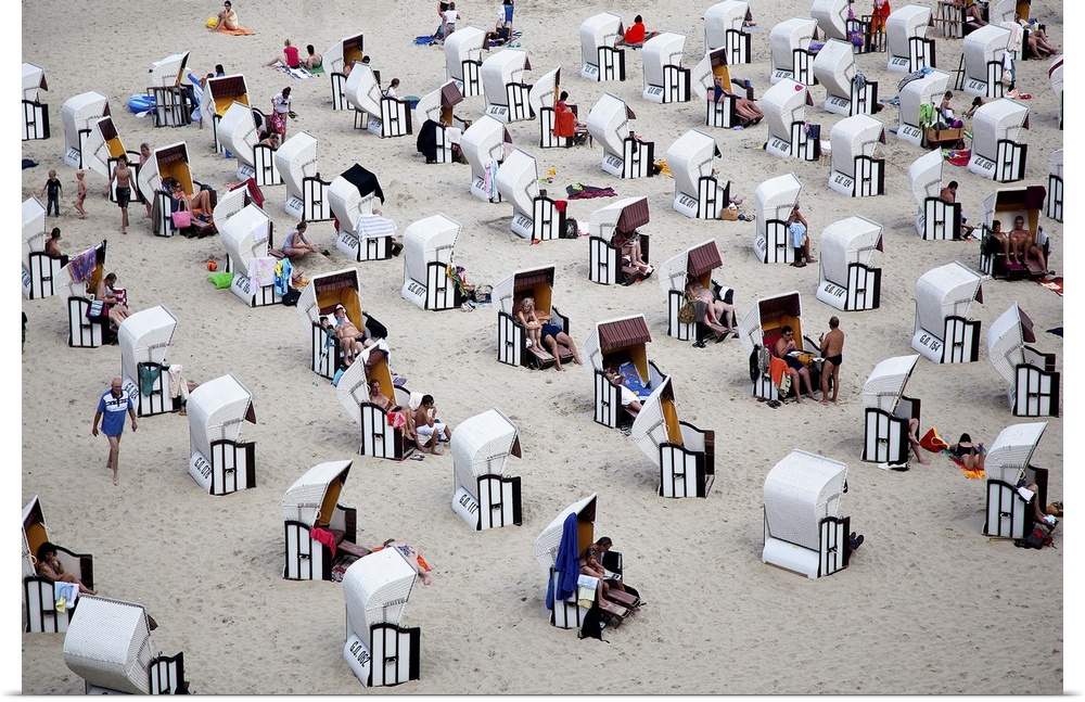 Rows of black and white cabanas on the beach, Italy.
