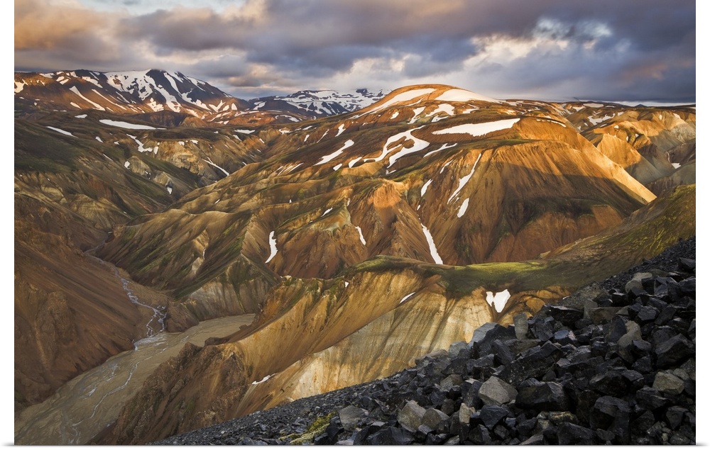 Mountain range with snow, lit up at sunset, Iceland.