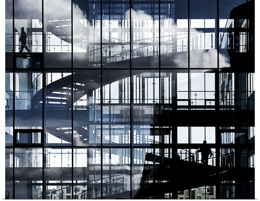 Abstract image created by a spiral staircase and glass windows of a buildling.