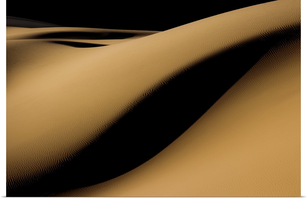 high contrast shadows create mystery as they roll over this sandy desert landscape, Iran.