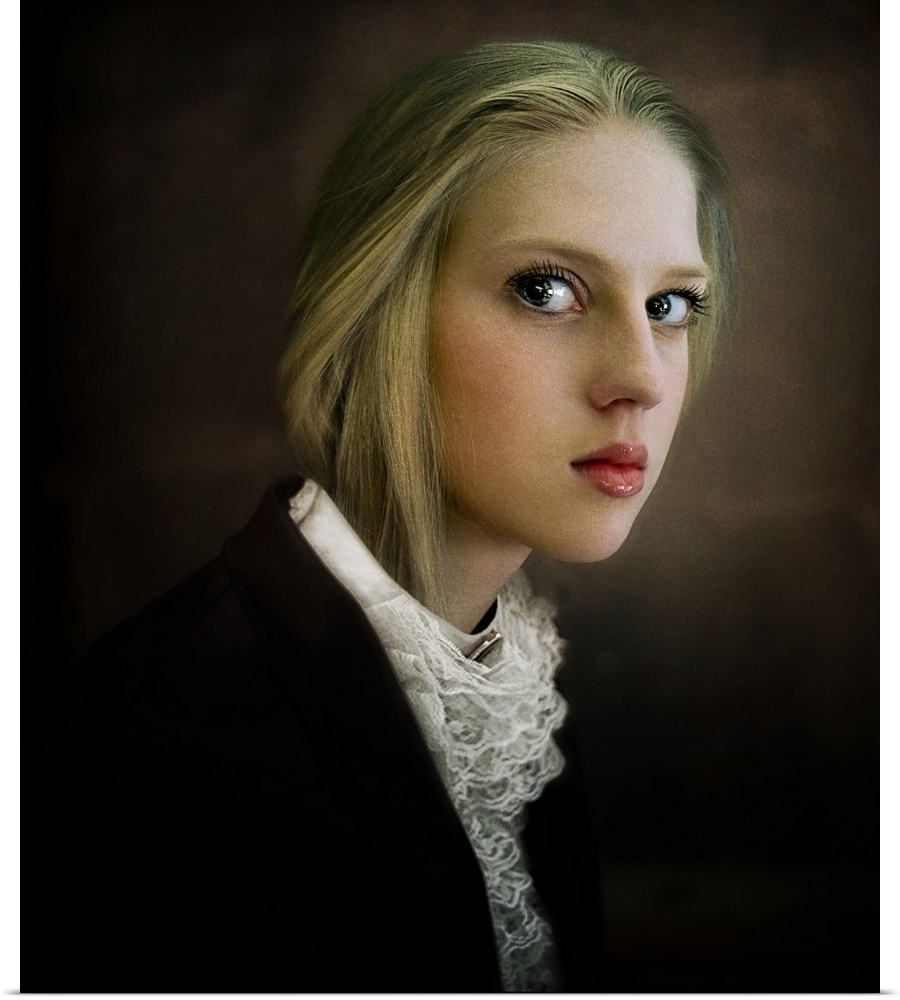 Portrait of a young blonde woman with large eyes and a lace blouse.