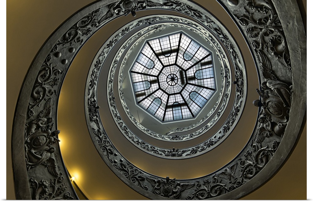 Abstract photograph of the spiral railing of the staircase at the Vatican leading up to the glass roof.