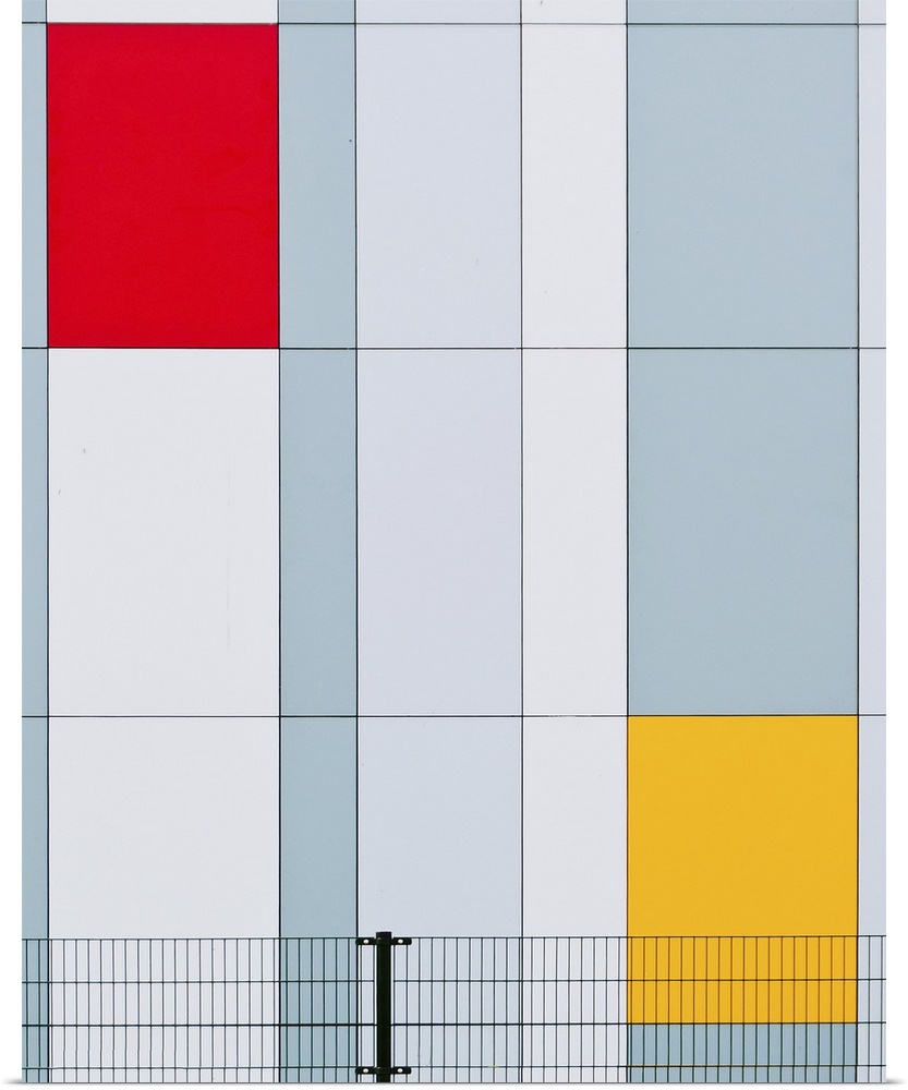 The facade of a building with red and yellow panels resembling a Mondrian painting.