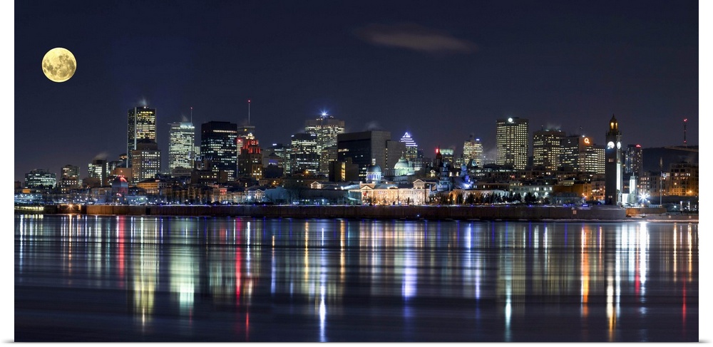 Colorful city lights of the Montreal skyline reflected in the water at night.
