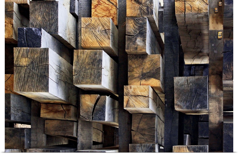 A stack of rectangular cut logs resembling an aerial shot of skyscrapers in a city. There are even small taxis in the uppe...