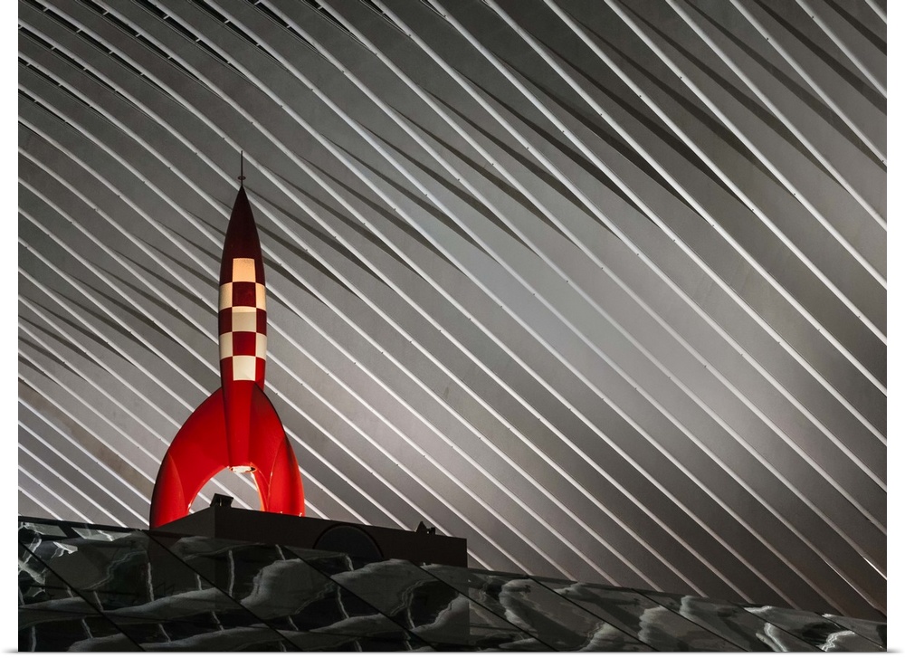 Sculpture of Tintin's rocket from the book series by Herge, illuminated from below.