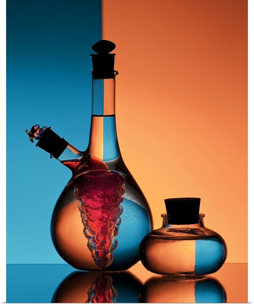 Two glass jars of oil and vinegar reflecting backwards images of the orange and blue walls in the background.