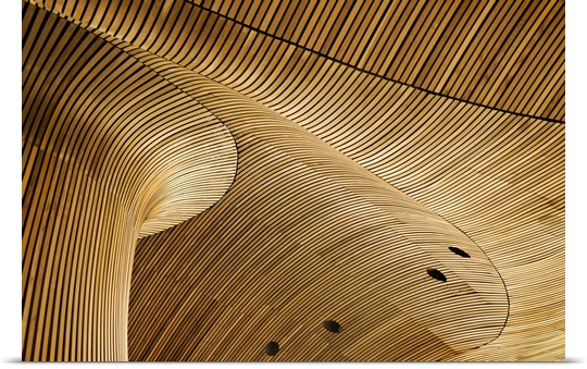 Architectural abstract made of curving wooden slats.