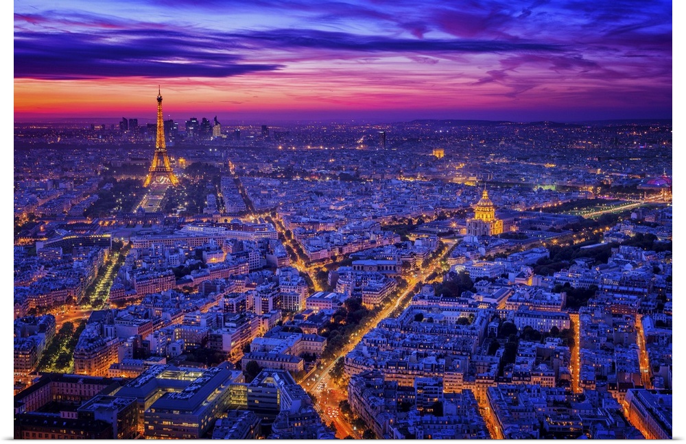 A night view of Paris with the Eiffel Tower in the distance lit up.