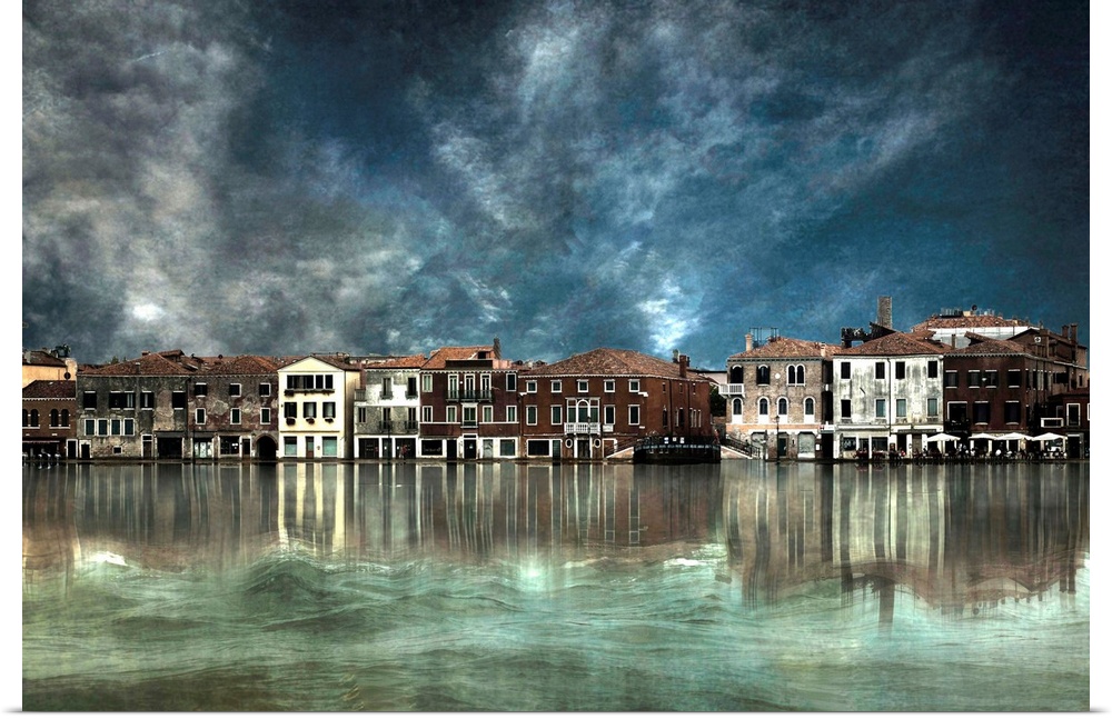 Row of buildings along the canal in Venice, Italy, with dark clouds overhead.