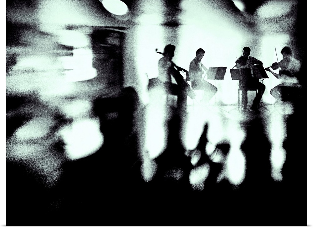 A quartet of musicians plays a piece, surrounded by blurred lights and shadows.