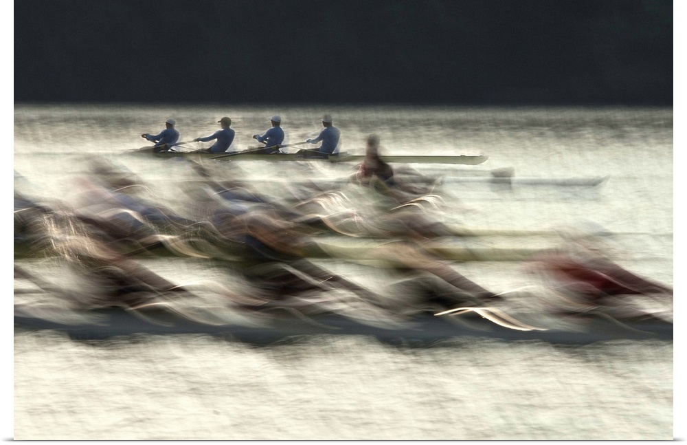 Long exposure photograph of rowing teams in a lake.