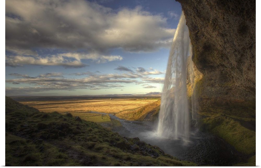 The Seljalandsfoss waterfall in Iceland, overlooking a wide open plain.