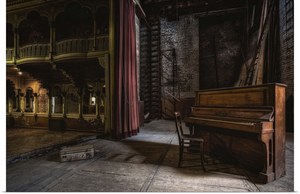 A derelict theatre with an old piano and chair on stage.