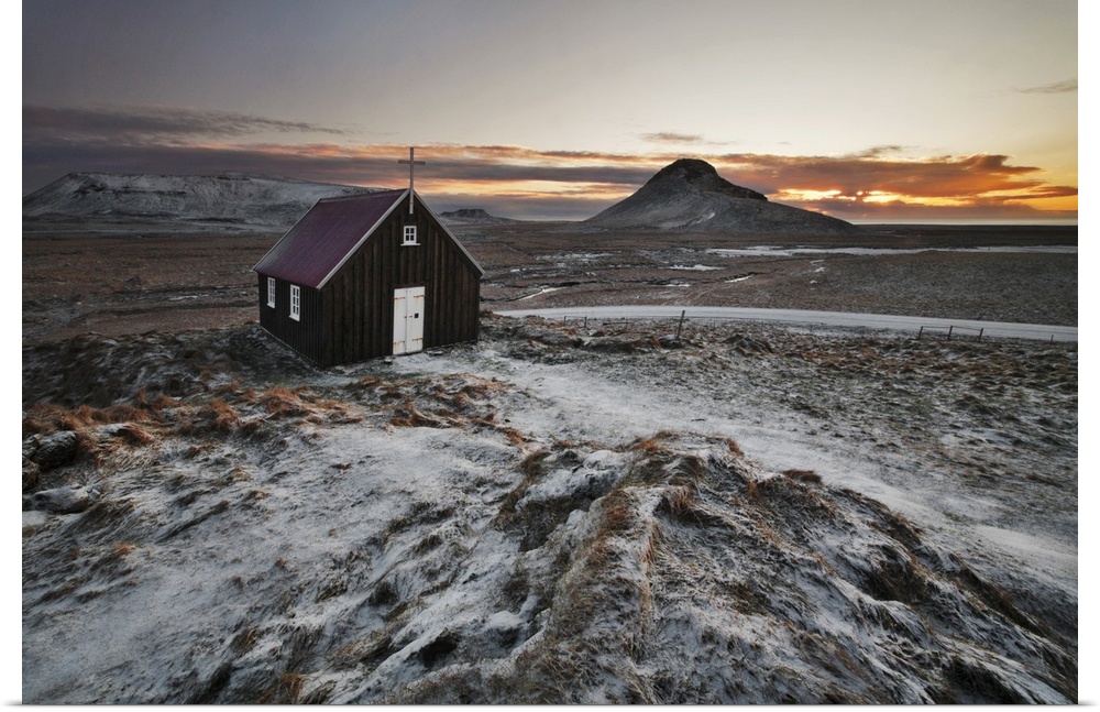 Small church in the icy rural landscape of Iceland, during sunset.