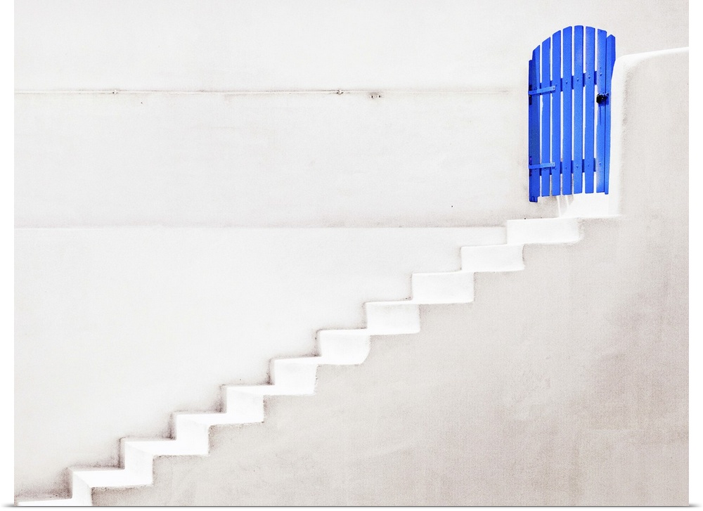 White staircase leading up to a brightly painted blue gate, Santorini, Greece.