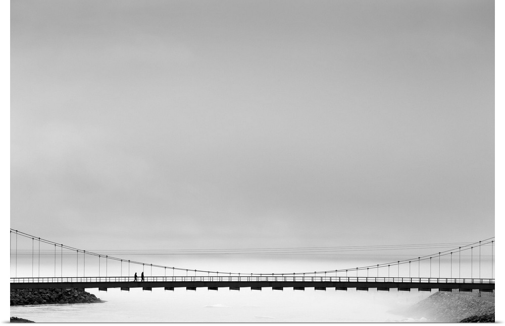 Black and white image of a bridge spanning the mists, Iceland.