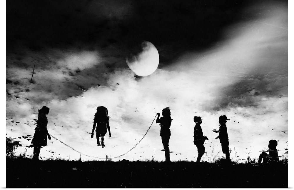 Children in silhouette jumping rope under the moonlight.