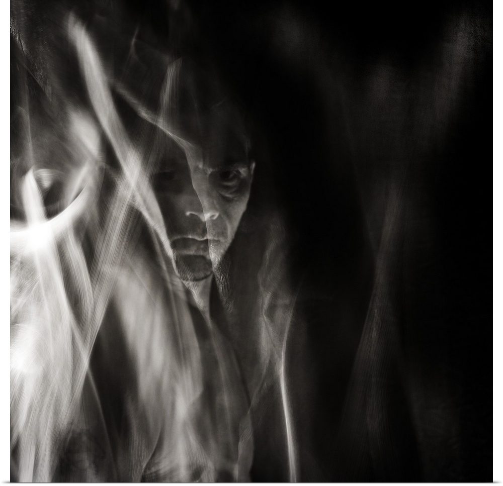 Square black and white surreal photograph of a man's face in the background with abstract smoke and haze in front.