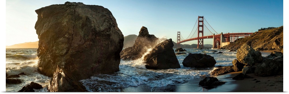 A rocky coastline view of the Golden Gate Bridge in San Francisco, California.
