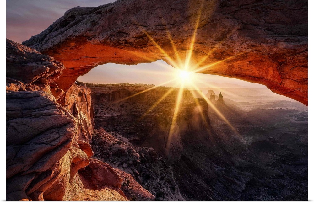 A view through the Mesa Arch in the Canyonlands national park in Utah at sunrise.