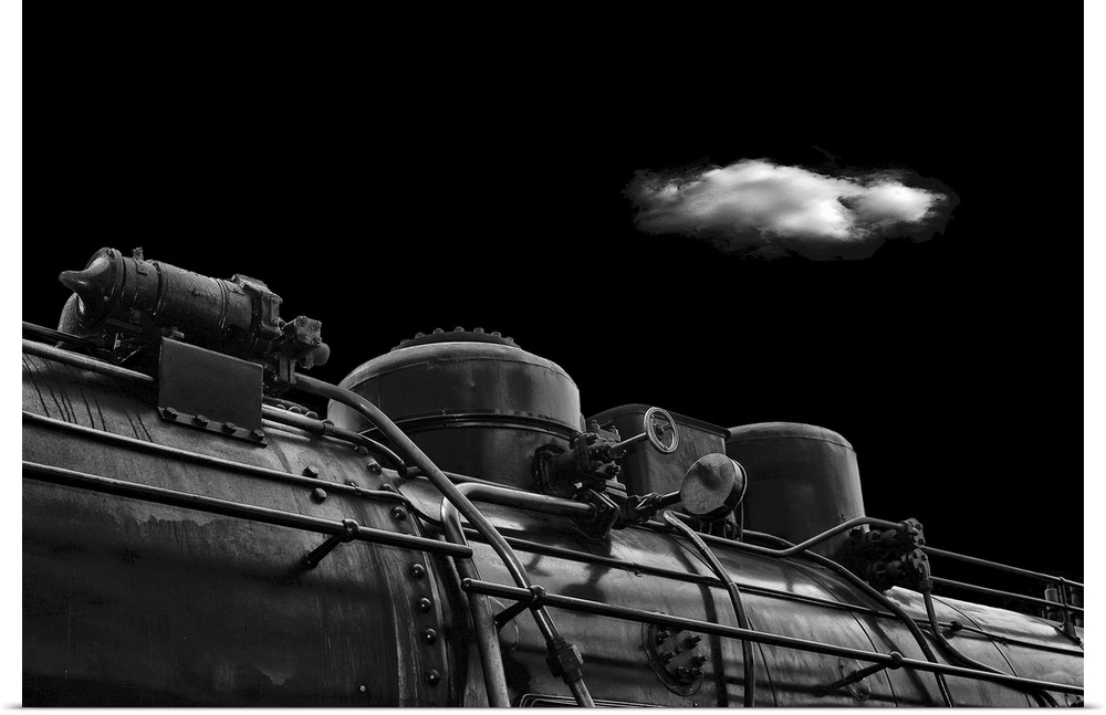 Detail of the iron pipes of an old steam train, with one cloud in the sky overhead.