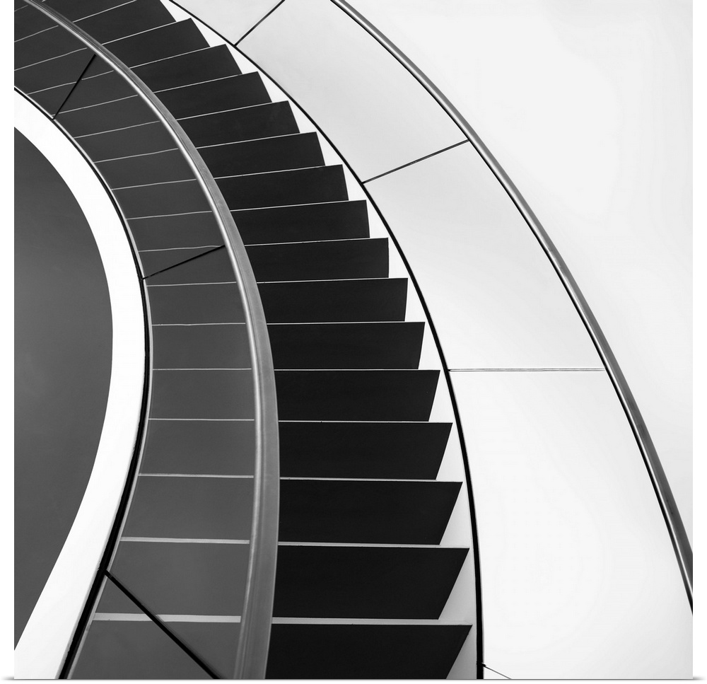 Black and white image of a staircase curving around.