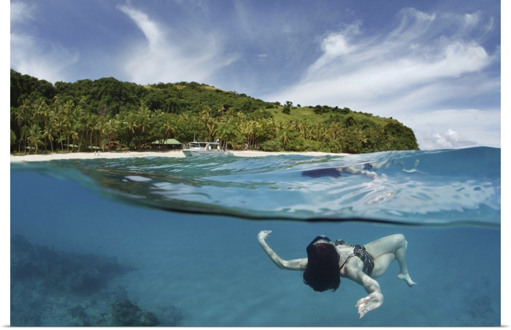 A woman swimming just below the surface of the water off the coast of Fiji.