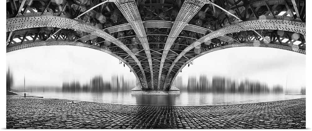 Black and white image of the underside of a bridge with complex scaffolding.