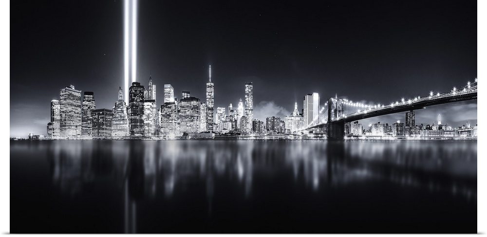Columns of light representing the fallen Twin Towers in New York City illuminate the skyline.