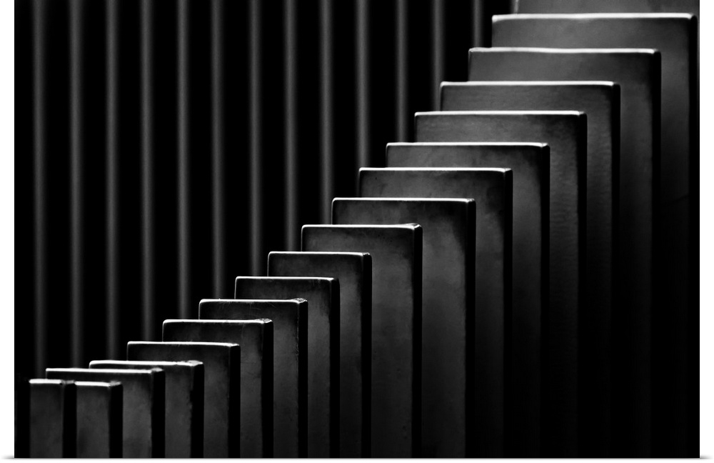 Abstract black and white photograph with leading lines made up of rectangular slits.