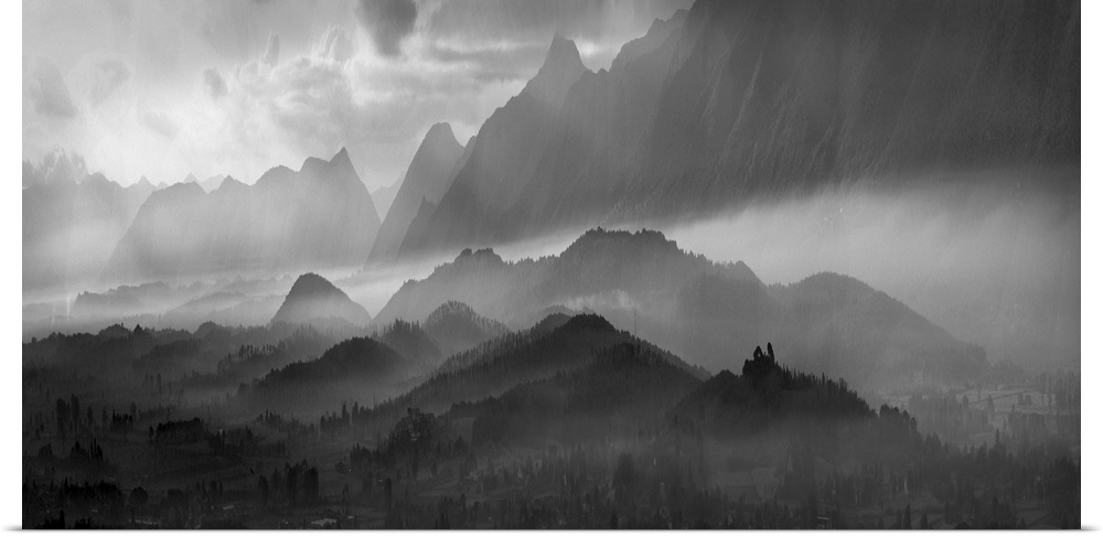Black and white image of a misty mountain landscape.