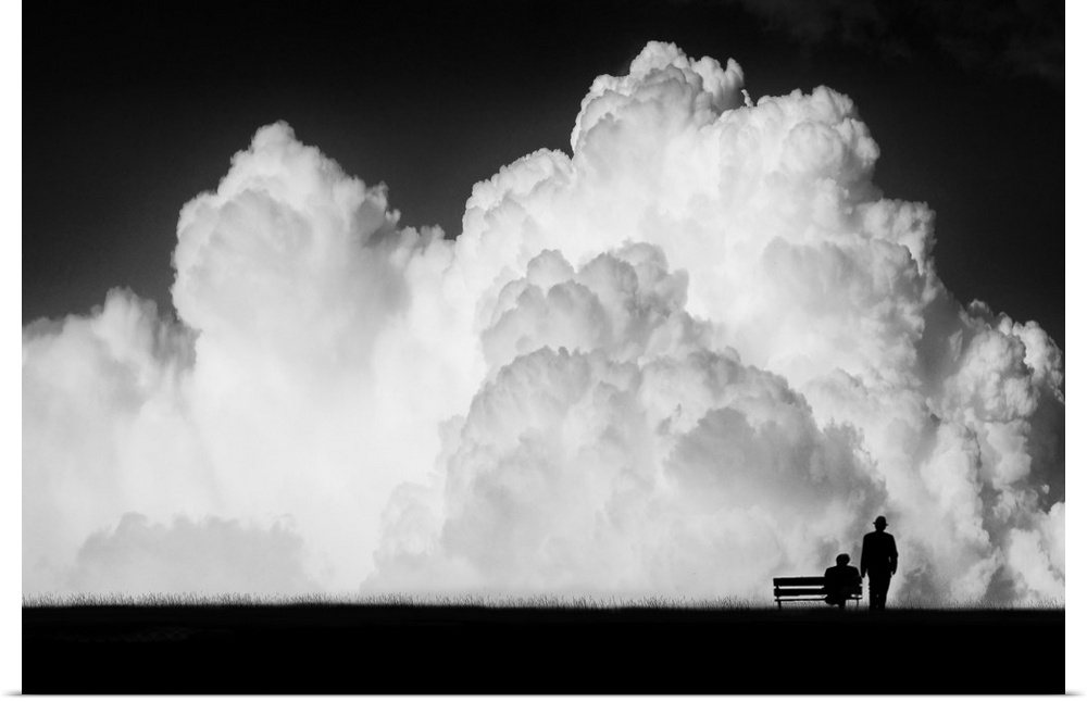 Figures and a bench dwarfed by gigantic stormclouds in the sky.