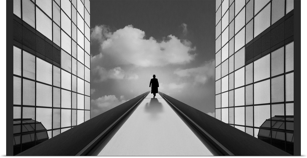 Conceptual image of a figure in a coat walking up a path between two glass bulidings.
