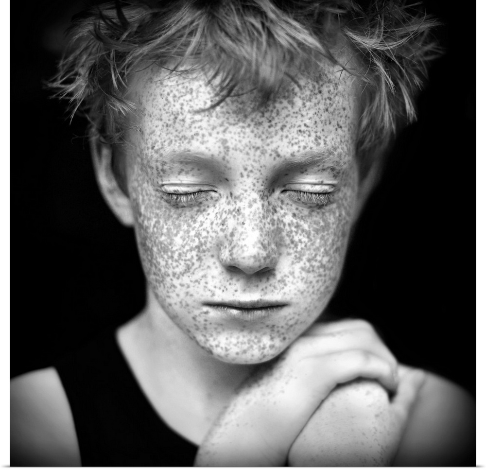 Black and white portrait of a young boy with freckles.