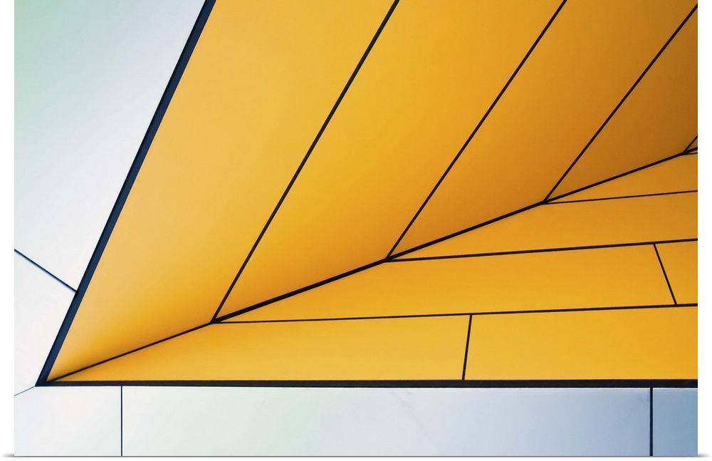 Yellow and white panels on an angular wall creating an abstract image.