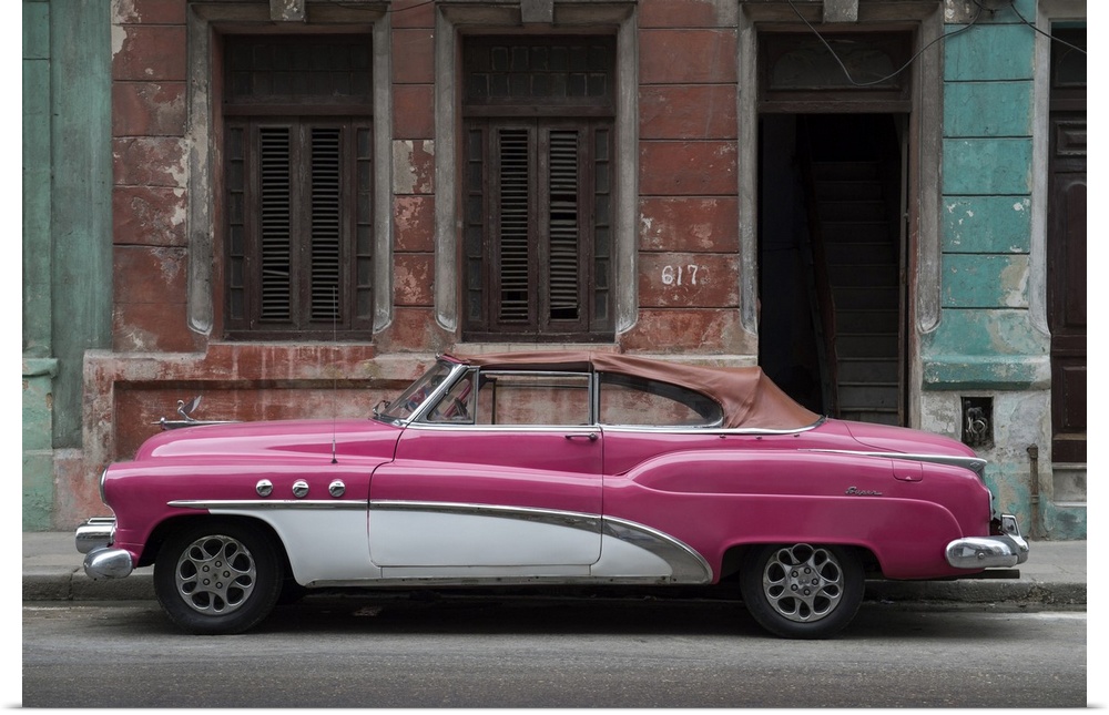 1950s classic American pink car set against a traditional Cuban house.