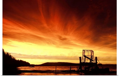 A fish wheel spins during sunrise on the Tanana River near the village of Tanana, Alaska